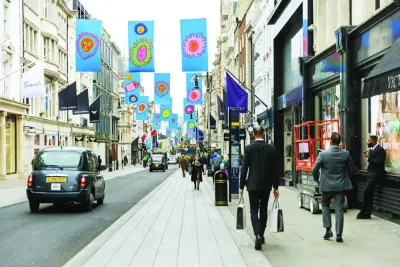 Pedestrians pass luxury stores on New Bond Street in central London. The volume of goods sold in stores and online rose 0.5% in January after a 1.2% decline in December, the Office for National Statistics said yesterday.