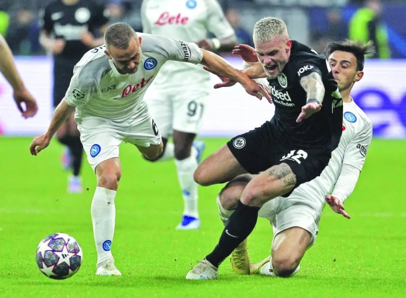 Frankfurt’s Philipp Max (centre) vies for the ball against Napoli’s Stanislav Lobotka (left) and Eljif Elmas during the UEFA Champions League round of 16 first leg match in Frankfurt, western Germany. (AFP)