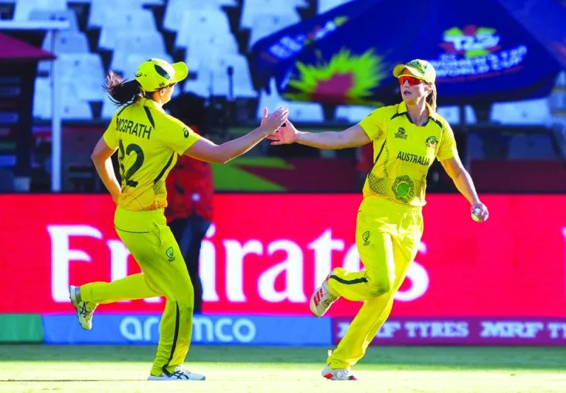 Australia’s Ellyse Perry celebrates with Tahlia McGrath after taking a catch to dismiss India’s Radha Yadav to win the ICC Women’s Cricket T20 World Cup semi-final at Newlands Cricket Ground, Cape Town, South Africa, on Thursday. (AFP)