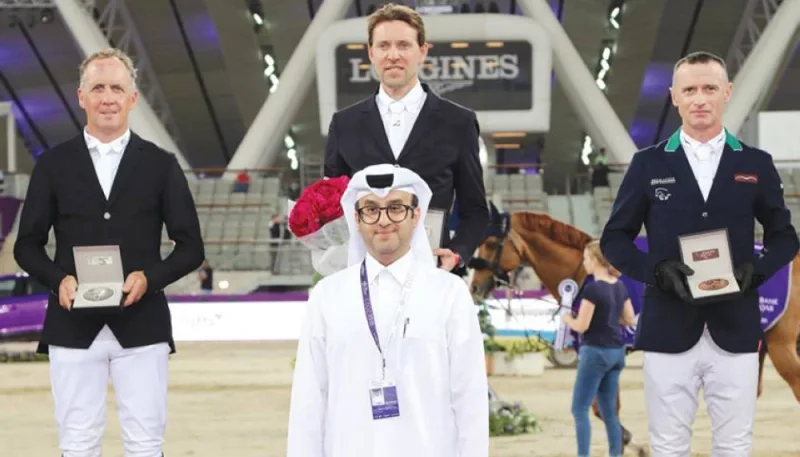 Hamad al-Suwaidi, founder and CEO of White Event, poses with the CSI5* 145cm class podium winners yesterday.
