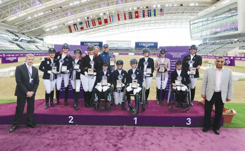 CPEDI3* Para Dressage Grand Prix B podium winners pose with their trophies at the Longines Arena at Al Shaqab.