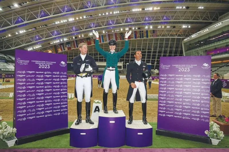 The Netherlands’ Dinja van Liere (centre) celebrates after winning the CDI 5* Dressage Grand Prix yesterday. Patrik Kittel (left) from Sweden finished second, while Spain’s Jose Antonio Garcia Mena was third.