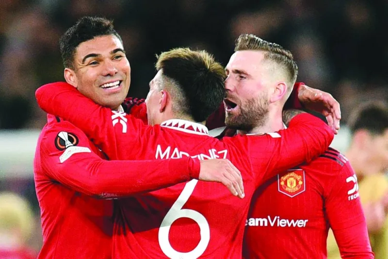 Manchester United’s Casemiro (left), Lisandro Martinez (centre) and Luke Shaw celebrate after their win over Barcelona in the UEFA Europa League knockout round play-off second leg match at Old Trafford Stadium in Manchester. (AFP)