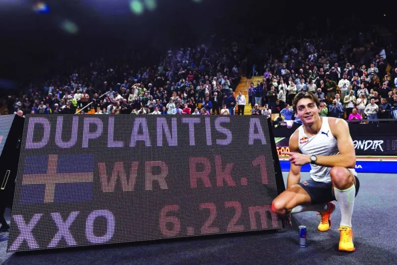 Sweden’s Armand Duplantis poses next to a digital board displaying his new pole vault world record in Clermont-Ferrand, central France, on Saturday. (AFP)