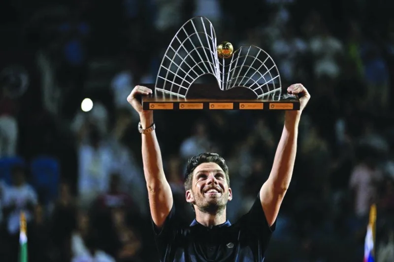 Britain’s Cameron Norrie raises the trophy after winning the ATP 500 Rio Open tournament in Rio de Janeiro, Brazil. (AFP)