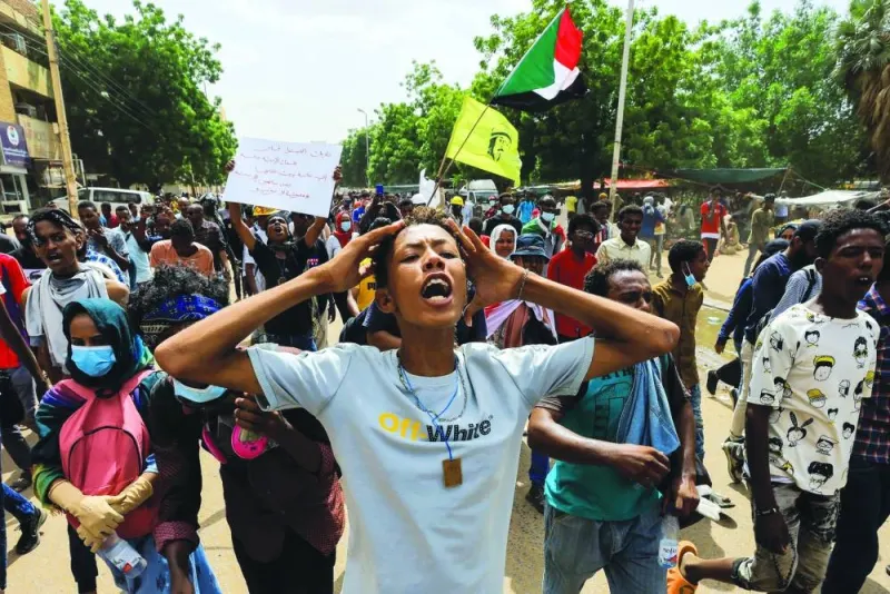Protesters march during a rally against military rule following the coup in Khartoum last July. (Reuters)