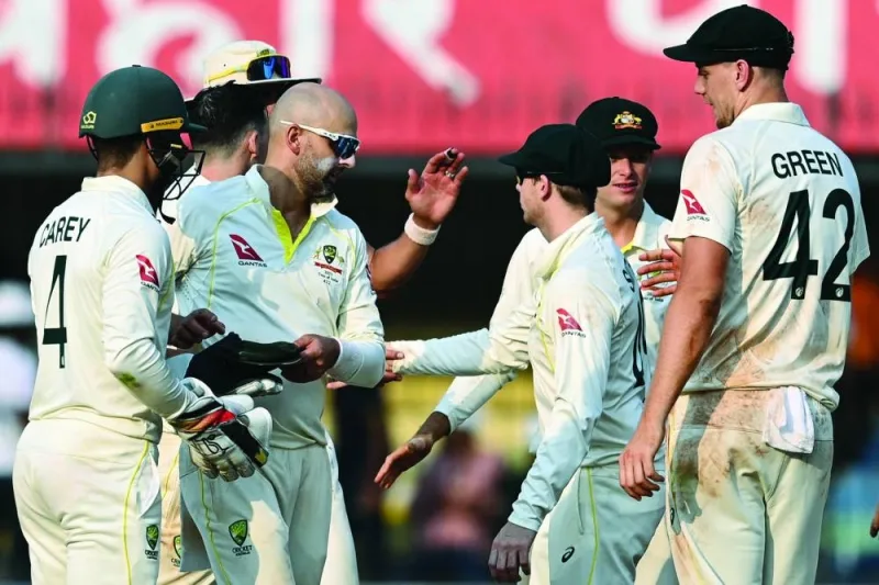 Australia’s players congratulate their teammate Nathan Lyon (third left) after he took eight wickets at the end of the second day of the third Test against India at the Holkar Stadium in Indore on Thursday. (AFP) 