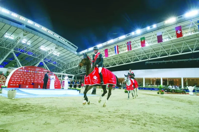 Riesenbeck International riders Christian Kukuk and Philipp Weishauppt celebrate after their win in the Global Champions League at the Longines Arena at Al Shaqab on Friday. PICTURES: Stefano Grasso / LGCT-GCL