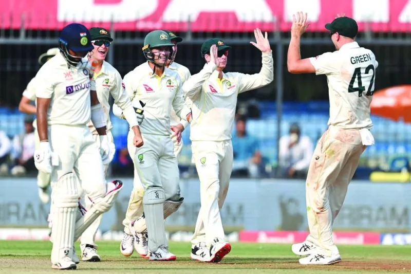 Australia’s Steve Smith (second right) celebrates with Cameron Green (right) after the dismissal of India’s Cheteshwar Pujara (left) during the second day of the third Test at the Holkar Stadium in Indore on Friday. (AFP) 