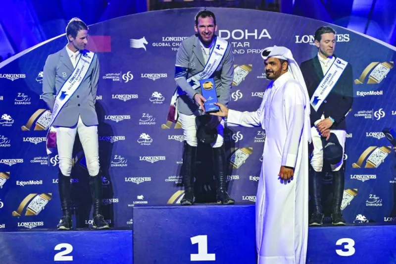 HE Sheikh Joaan bin Hamad al-Thani, President of the Qatar Olympic Committee, presents the trophy to Longines Global Champions Tour Grand Prix of Doha champion Philipp Weishaupt of Germany at the Longines Arena at Al Shaqab yesterday. Christian Kukuk (left), also from Germany, finished second, while France’s Simon Delestre came third.