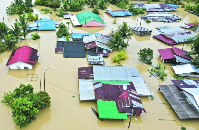 An aerial view shows flooded houses in Yong Peng, Malaysia’s Johor state, yesterday. (AFP)