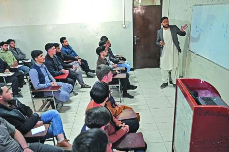 Male students attend their computer science class after the universities were reopened in Kabul on Monday. (AFP)