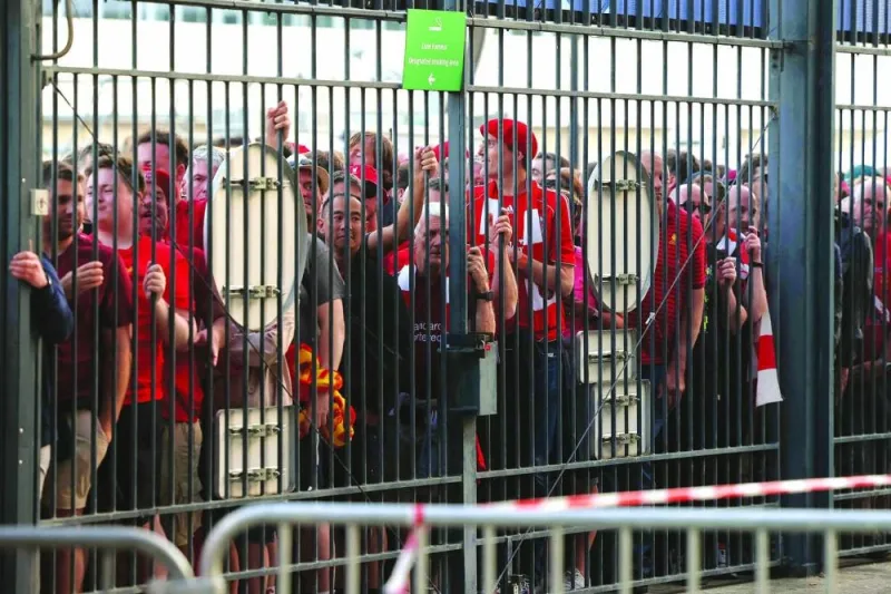In this file photo taken on May 28, 2022, Liverpool fans stand outside unable to get in leading to the match being delayed prior to the UEFA Champions League final between Liverpool and Real Madrid at the Stade de France in Saint-Denis, north of Paris. (AFP)