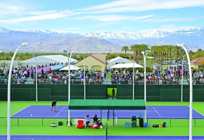 Fans fill the seats as they watch players on the practice courts with the snow capped San Jacinto Mountains in the background during day 1 of the BNP Paribas Open at the Indian Well Tennis Garden. (USA TODAY Sports)