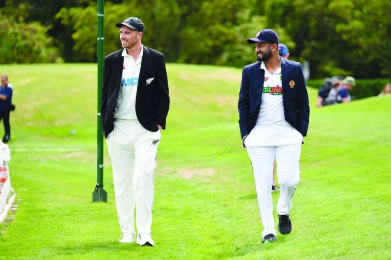 New Zealand’s captain Tim Southee (left) and Sri Lanka’s captain Dimuth Karunaratne walk back to the pavilion after attending a media opportunity ahead of the Test series at Hagley Oval in Christchurch 
yesterday. The series starts tomorrow. (AFP)