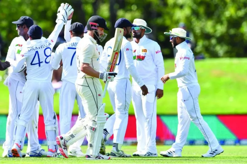 New Zealand’s Kane Williamson (centre) walks back to the pavilion after his dismissal as Sri Lankan players celebrate during the second day of the first Test at Hagley Oval in Christchurch yesterday. (AFP)