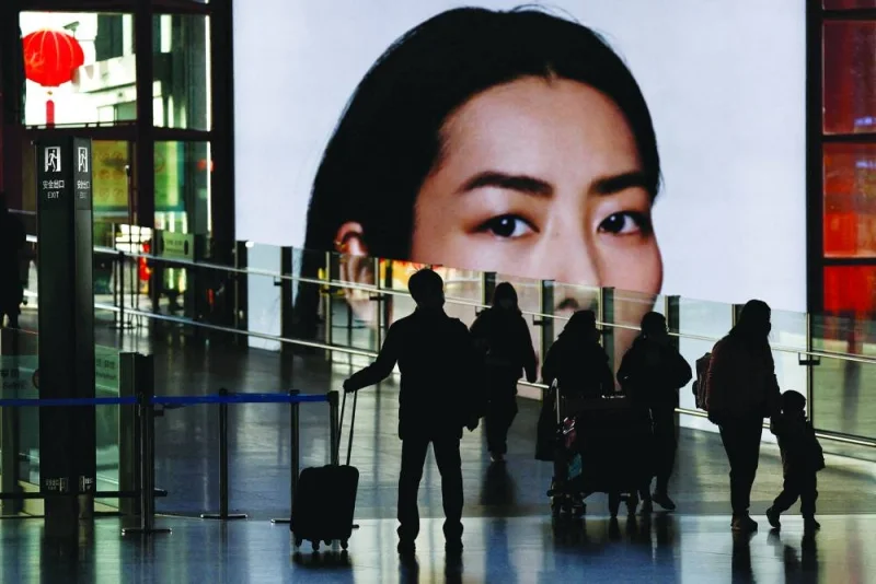 Travellers walk at a terminal hall, during the annual Spring Festival travel rush ahead of the Chinese Lunar New Year, in Beijing Capital International Airport. China reported a rebound in consumer spending, industrial output and investment this year after coronavirus restrictions were dropped, while warning of risks to the economy’s recovery as unemployment rose and real estate investment continued to slump.