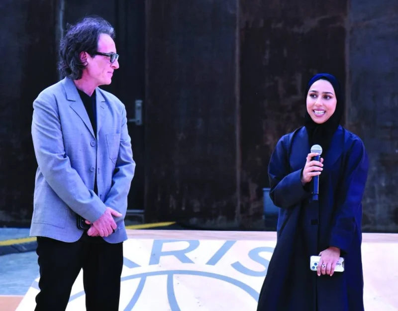 Calligraffiti artist Fatima al-Sharshani speaks at the unveiling of the new collection yesterday as PSG's chief brand officer Fabien Allegre looks on. PICTURES: Thajudheen.