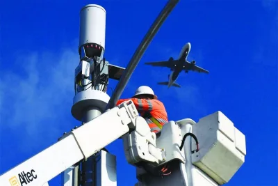 A contractor installs 5G equipment on a light pole near Los Angeles International Airport in California. Global aviation is facing significant challenges as time is fast running out for airlines to meet proposed regulatory deadlines in the United States to ensure they won’t suffer interference from 5G C-band transmissions from towers located near US airports and approach paths.