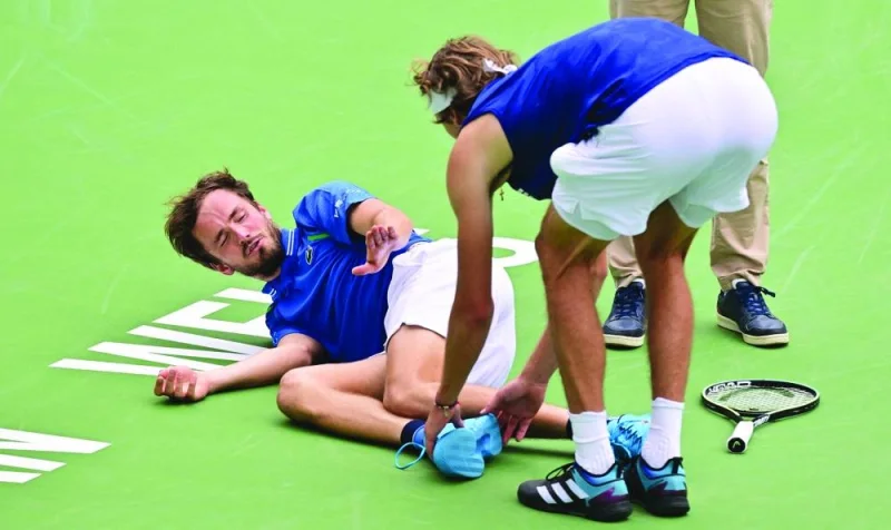 Daniil Medvedev of Russia reacts as Alexander Zverev of Germany touches his foot after Medvedev had a fall during their Indian Wells Masters match. (AFP)