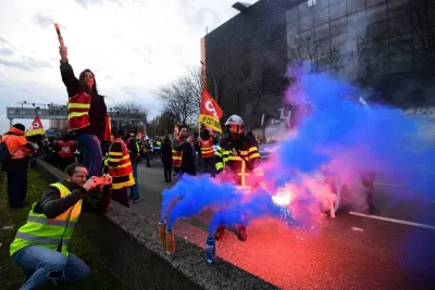 CGT unionists march with flares and banners on the ring road in Paris, blocking traffic to protest after the French government pushed a pensions reform through parliament without a vote.