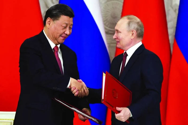 Russian President Vladimir Putin shakes hands with Chinese President Xi Jinping during a signing ceremony following their talks at the Kremlin in Moscow yesterday. (Reuters)