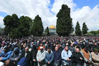 Palestinians perform the second Friday prayer of the holy fasting month of Ramadan in front of the mosque at the Al-Aqsa mosque complex in Jerusalem, yesterday.