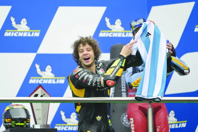 Ducati Italian rider Marco Bezzecchi shows the Argentine jersey signed by Lionel Messi he was presented for his first win, on the podium of the Argentina Grand Prix MotoGP race, at Termas de Rio Hondo circuit in Santiago del Estero, Argentina, yesterday. (AFP)