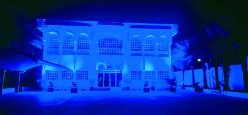 The Hope Qatar building lit up in blue.