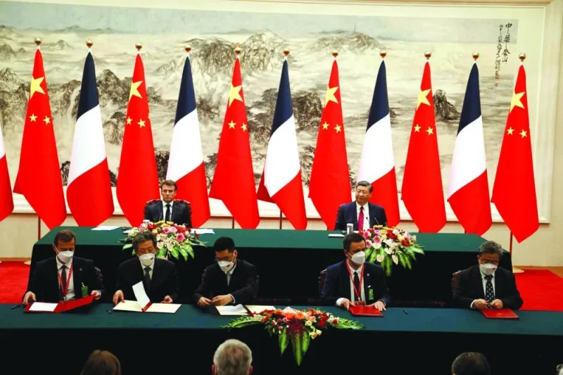 Airbus CEO Guillaume Faury (left) and EDF CEO Luc Remont (second right) sign agreements with their Chinese counterparts in the presence of French President Emmanuel Macron (back-left) and Chinese President Xi Jinping (back-right) during the state visit in Beijing yesterday.