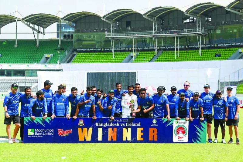 Bangladesh’s players pose with the trophy after winning the one-off Test against Ireland at the Sher-e-Bangla National Cricket Stadium in Dhaka yesterday. (AFP)