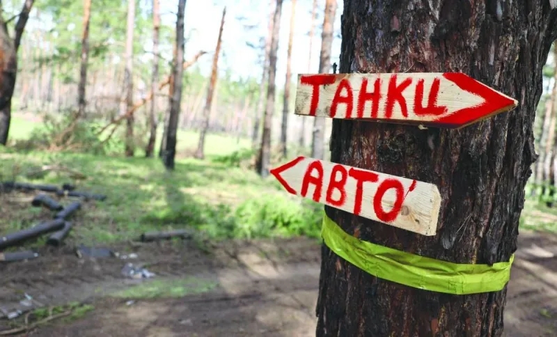 Signs reading ‘tanks’ (top) and ‘cars’, to guide Ukrainian troops, are seen stuck on a tree near the frontline in the region of Lyman, Ukraine.