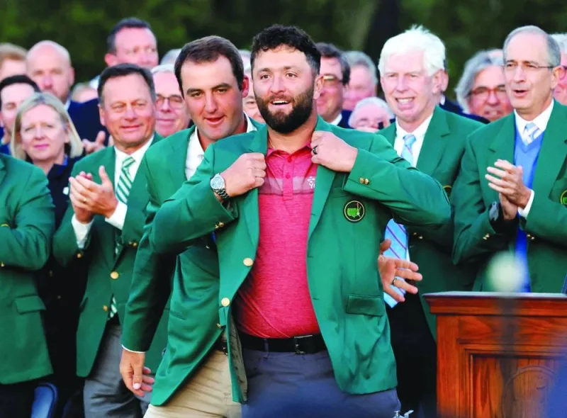 Spain’s Jon Rahm is presented with the green jacket by Scottie Scheffler of the US after winning The Masters at Augusta National Golf Club in Augusta, Georgia. (Reuters)