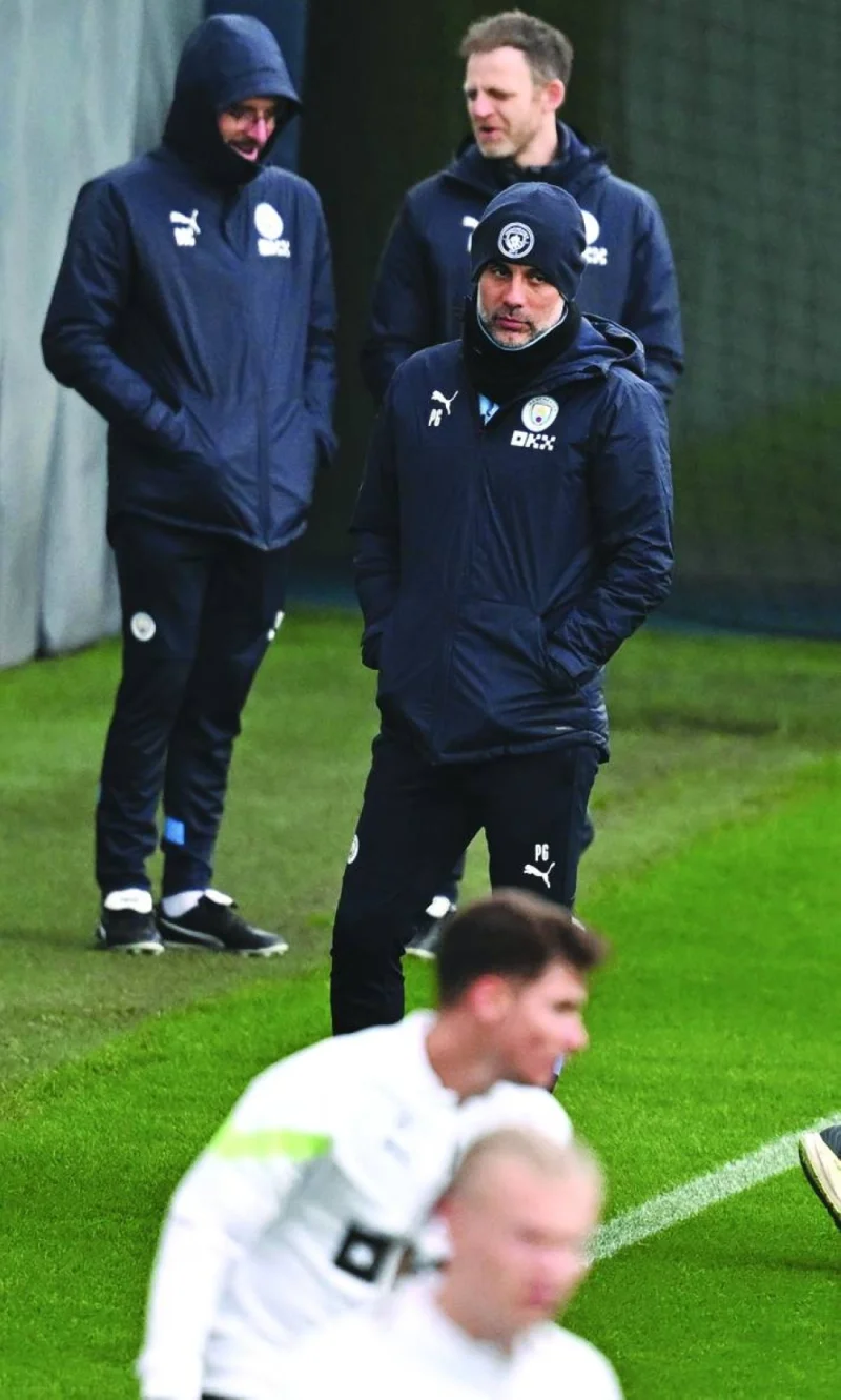 Manchester City's manager Pep Guardiola attends a team training session at Manchester City training ground in Manchester yesterday, on the eve of their UEFA Champions League quarter-final first leg match against Bayern Munich. (AFP)