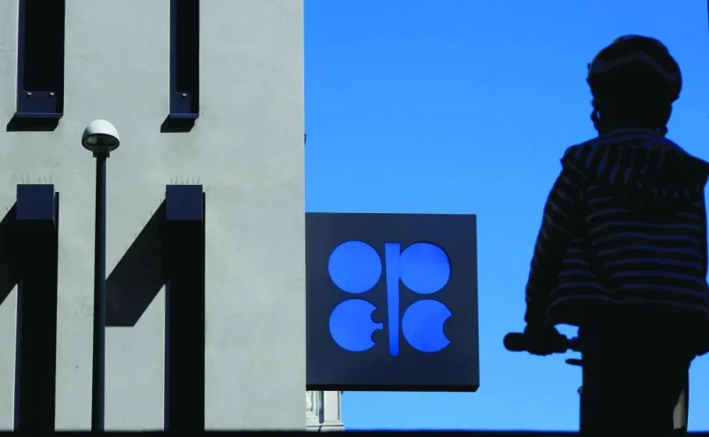 A person passes the logo of Opec in front of its headquarters in Vienna, Austria. Opec yesterday flagged downside risks to summer oil demand as part of the backdrop to shock output cuts announced by Opec+ producers on April 2, although the producer group maintained its forecast for global oil demand growth in 2023.
