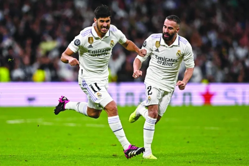 Real Madrid’s Marco Asensio (left) celebrates with Dani Carvajal after scoring against Chelsea during the UEFA Champions League first leg quarter-final at the Santiago Bernabeu Stadium in Madrid on Wednesday. (AFP)