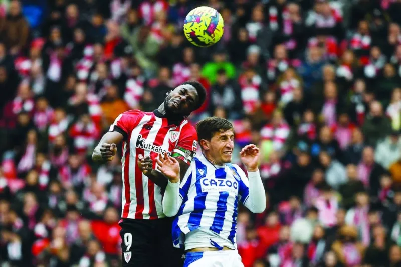 Athletic Bilbao’s Inaki Williams (left) and Real Sociedad’s Aihen Munoz vie for an header during the La Liga match at the San Mames Stadium in Bilbao, Spain, yesterday. (AFP)