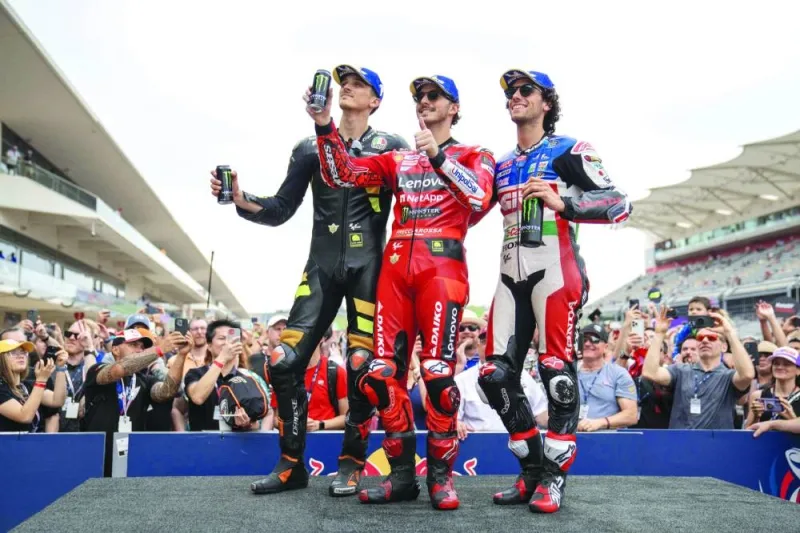 Francesco Bagnaia of Ducati Lenovo Team (centre), Luca Marini of Italy Mooney VR46 Racing Team and Alex Rins LCR Honda Castrol (right) pose on the podium after the qualifying round for MotoGP of the Americas in Austin on Saturday. (Reuters)