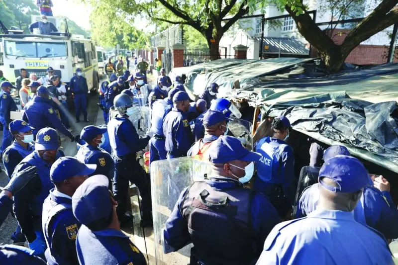 South African Police Service (SAPS) officers carry out evictions from temporary dwellings built in front of the UN High Commissioner for Refugees (UNHCR) offices in Pretoria, on Friday.
