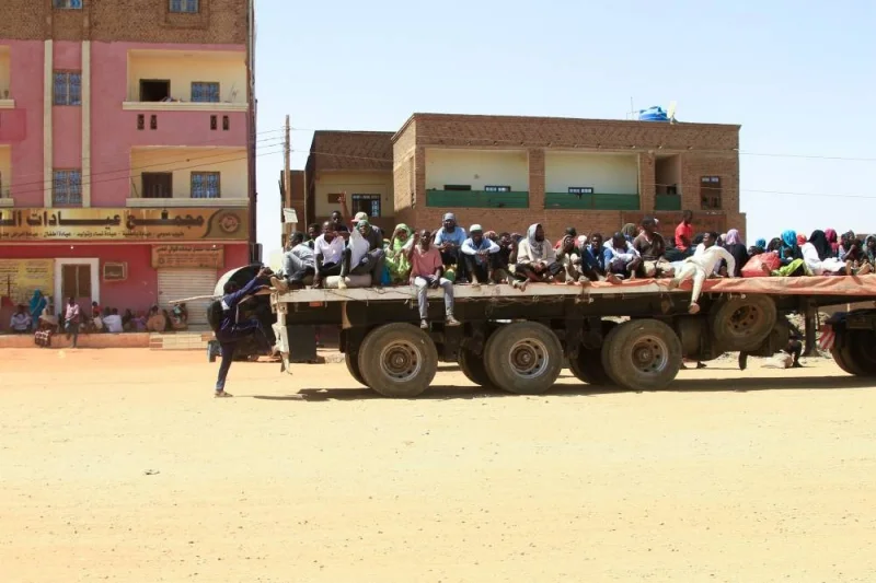 People fleeing street battles between the forces of two rival Sudanese generals, are transported on the back of a truck in the southern part of Khartoum. AFP