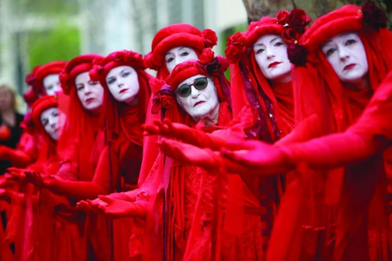 Members of performance troupe Red Rebel Brigade march in central London at a demonstration by the climate change protest group Extinction Rebellion on Saturday.