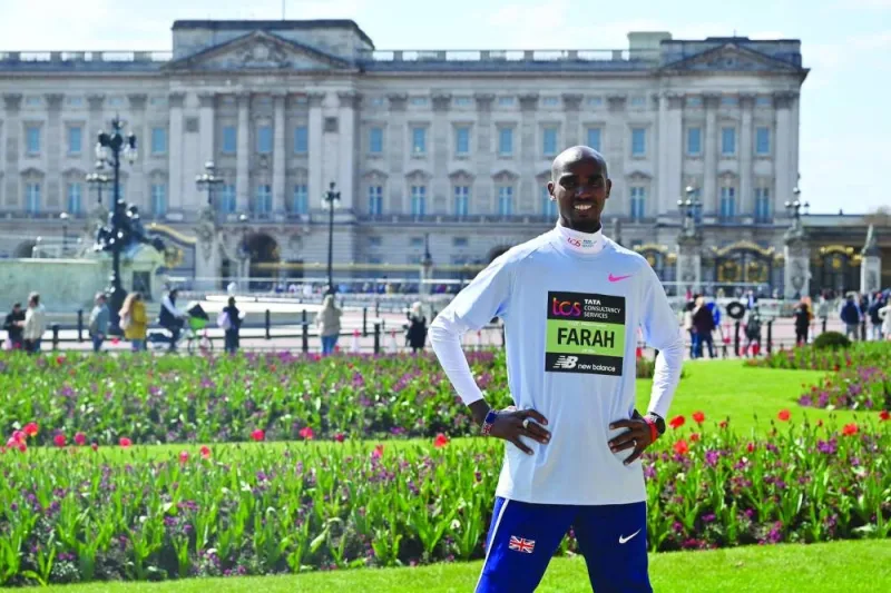 Mo Farah poses outside Buckingham Palace in London ahead of the London marathon. (AFP)