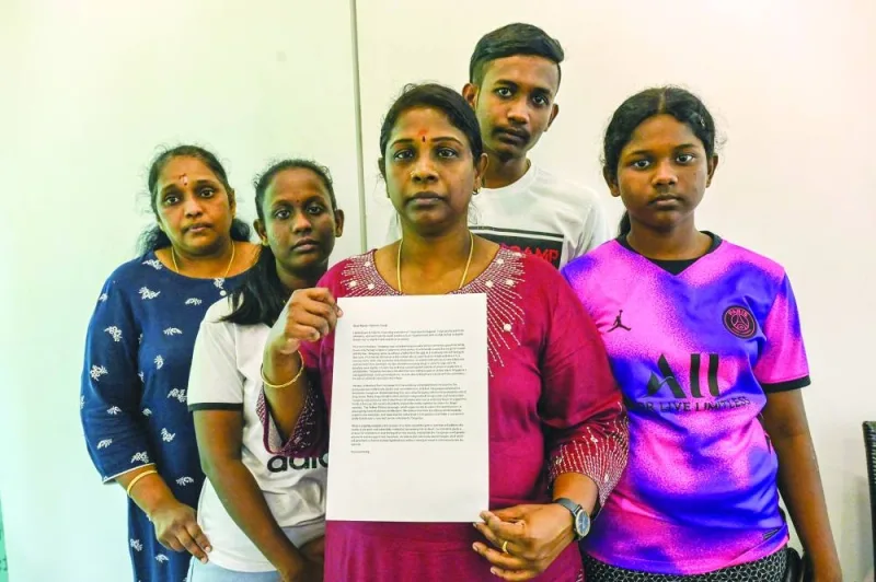 Leelavathy Suppiah (centre), sister of a convicted drug trafficker Tangaraju Suppiah, who is scheduled for execution, poses with family members as she holds a petition letter to seek clemency in Singapore, yesterday.