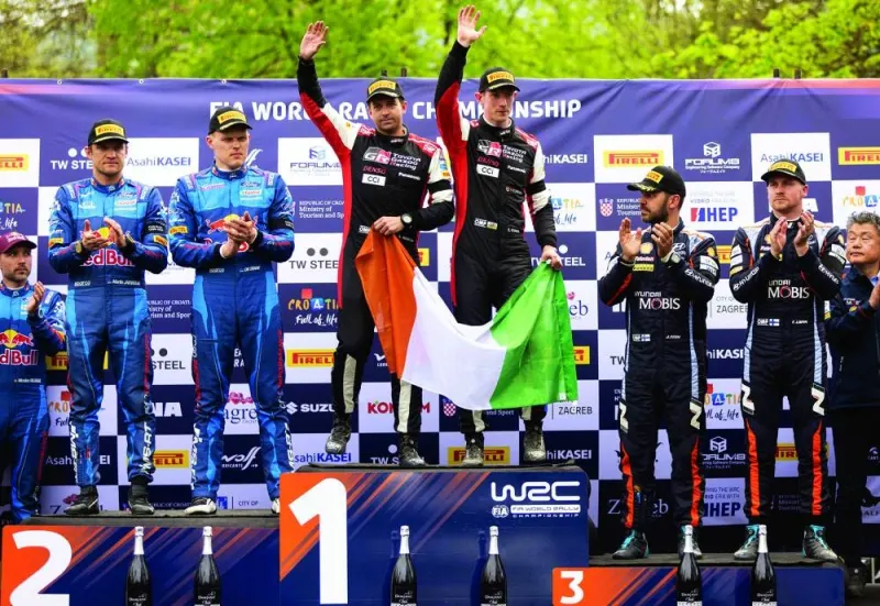Winners British driver Elfyn Evans and British co-driver Scott Martin of Toyota Gazoo Racing pose on the podium after the Croatia Rally 2023, part of the FIA World Rally Championship, in Kumrovec, Croatia, on Sunday. (AFP)