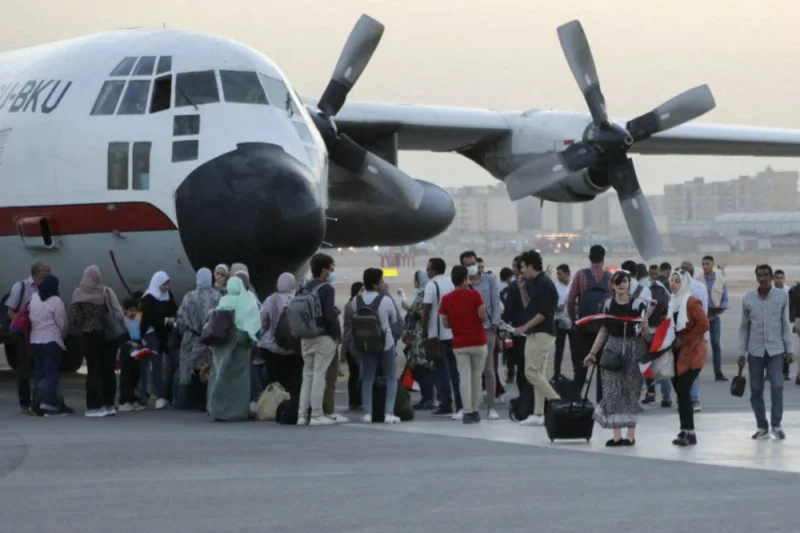 Egyptian evacuees from Sudan disembarking upon landing in Cairo. AFP PHOTO / EGYPTIAN ARMY