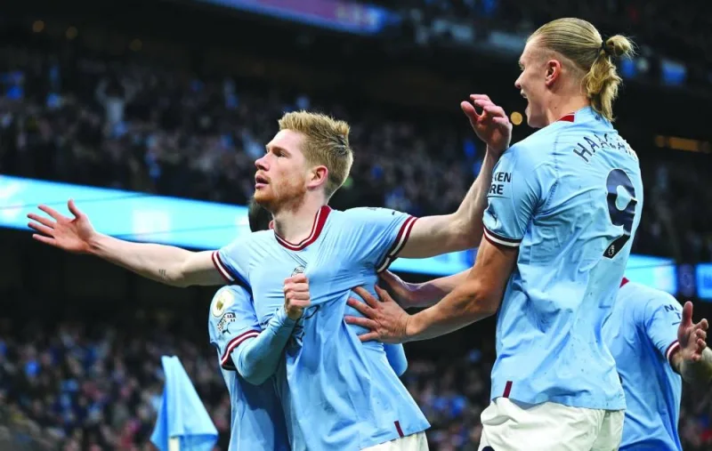 Manchester City’s Kevin De Bruyne (left) celebrates scoring the opening goal with teammate Erling Haaland during the English Premier League match against Arsenal in Manchester on Wednesday. (AFP)
