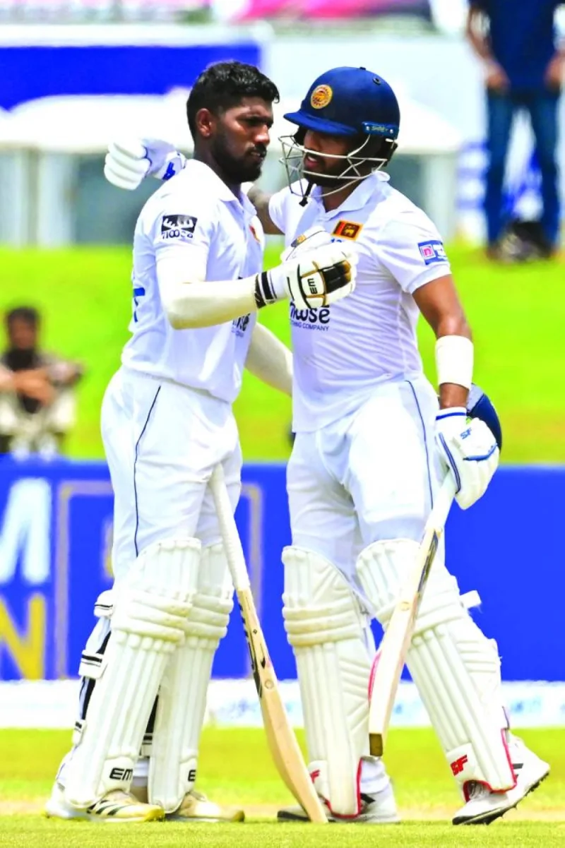 Sri Lanka’s Nishan Madushka celebrates with his teammate Kusal Mendis (right) after scoring a double century during fourth day of the second and final Test against Ireland in Galle on Thursday. (AFP)
