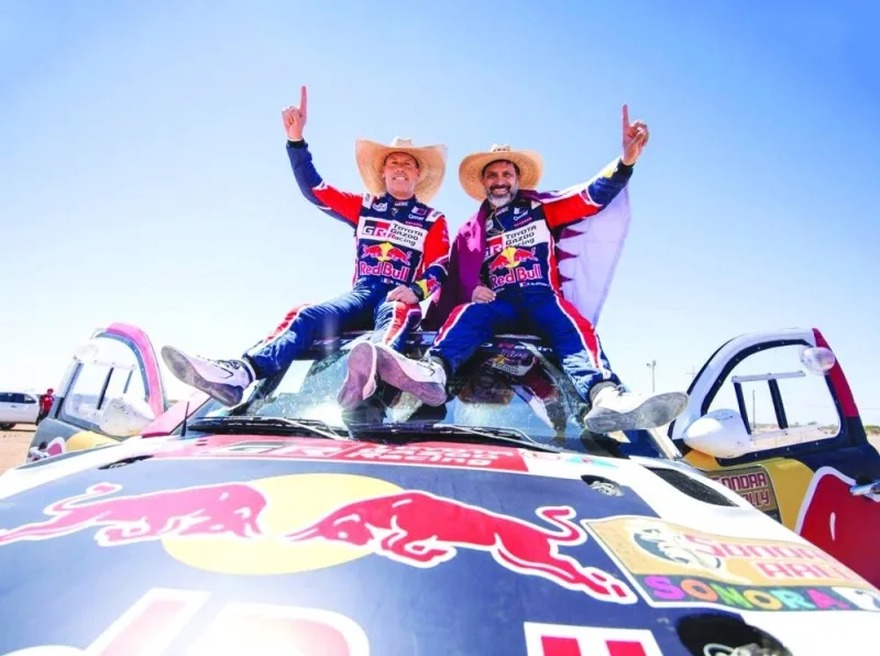 Nasser al-Attiyah and his French co-driver Mathieu Baumel celebrate after winning the Sonora Rally in northern Mexico Friday