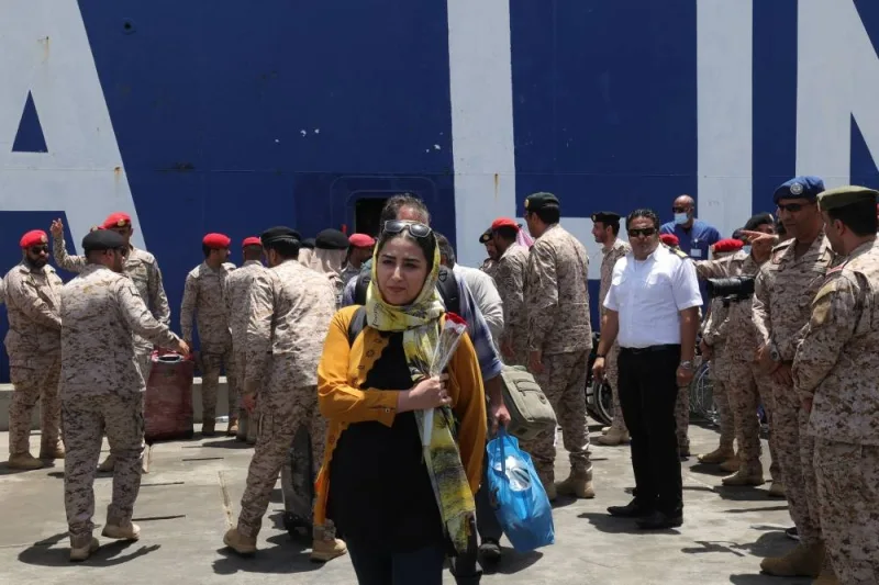 Evacuees are welcomed by Saudi soldiers as they step off a ferry which transported some 1900 people across the Red Sea from Port Sudan to the Saudi King Faisal navy base in Jeddah, during mass evacuations from Sudan.  AFP