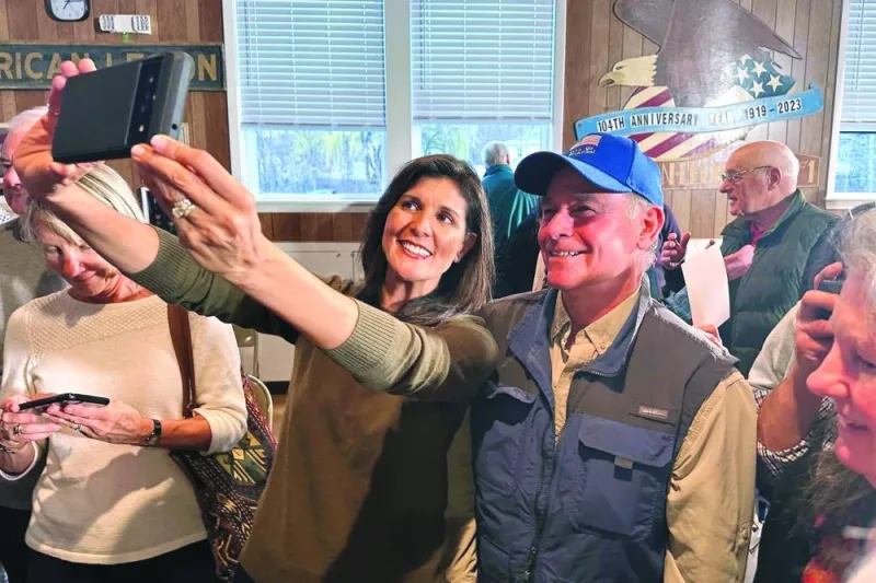Nikki Haley takes a picture with a supporter following a town hall event at an American Legion centre in Laconia, New Hampshire.